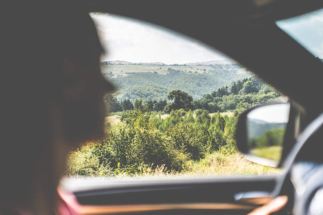 Download Man Driving a Car in Countryside FREE Stock Photo