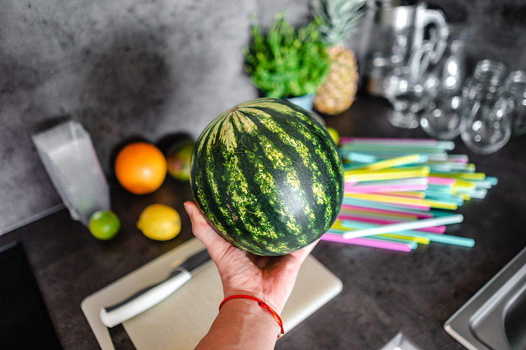 Download Man Holding a Small Watermelon FREE Stock Photo