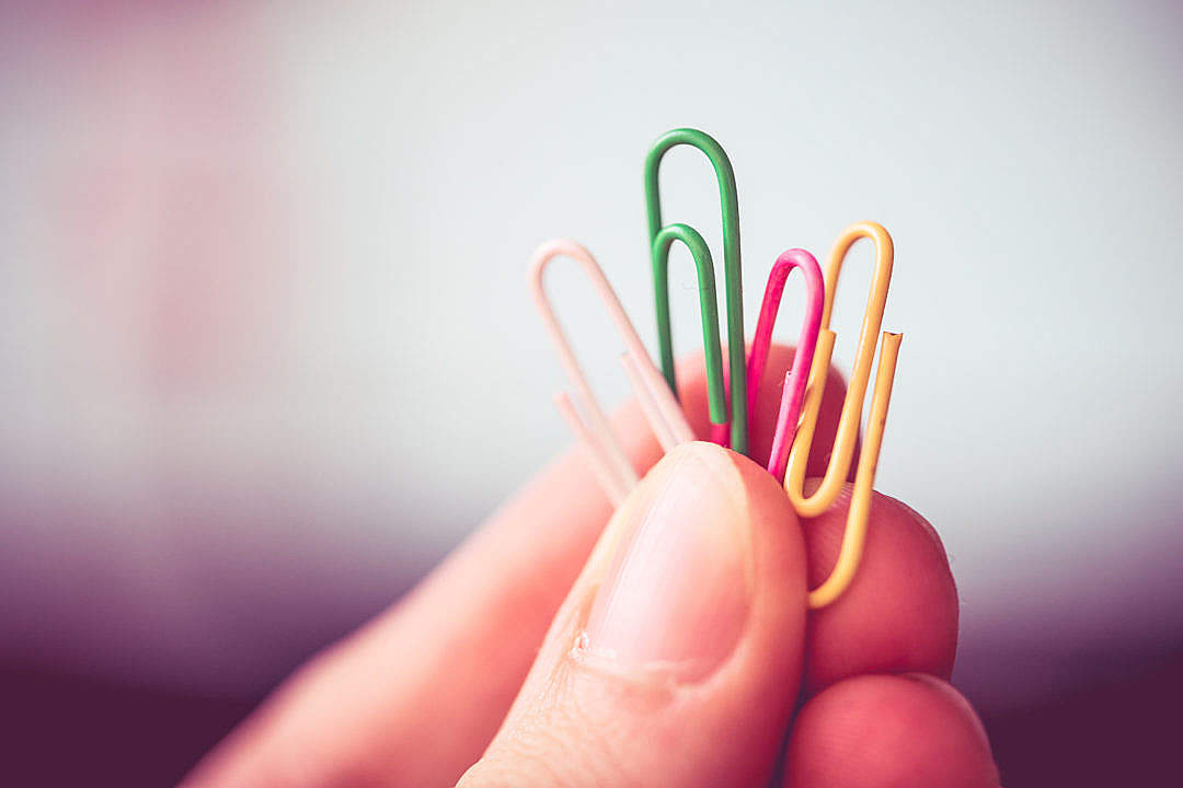 Download Man Holding Colorful Paper Clips FREE Stock Photo