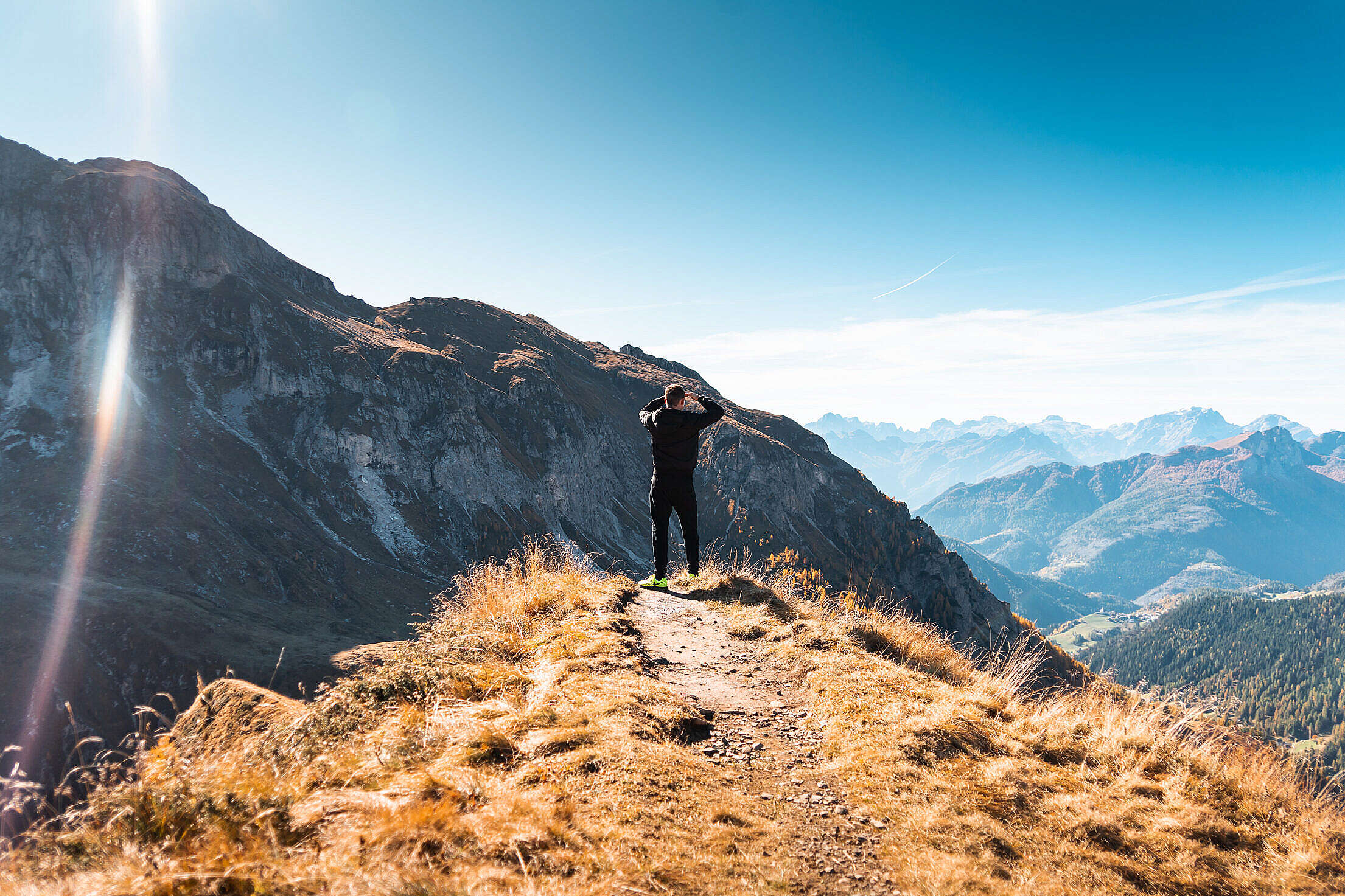 Man Standing on a Mountain and Looking out over The Scenery Free Stock Photo