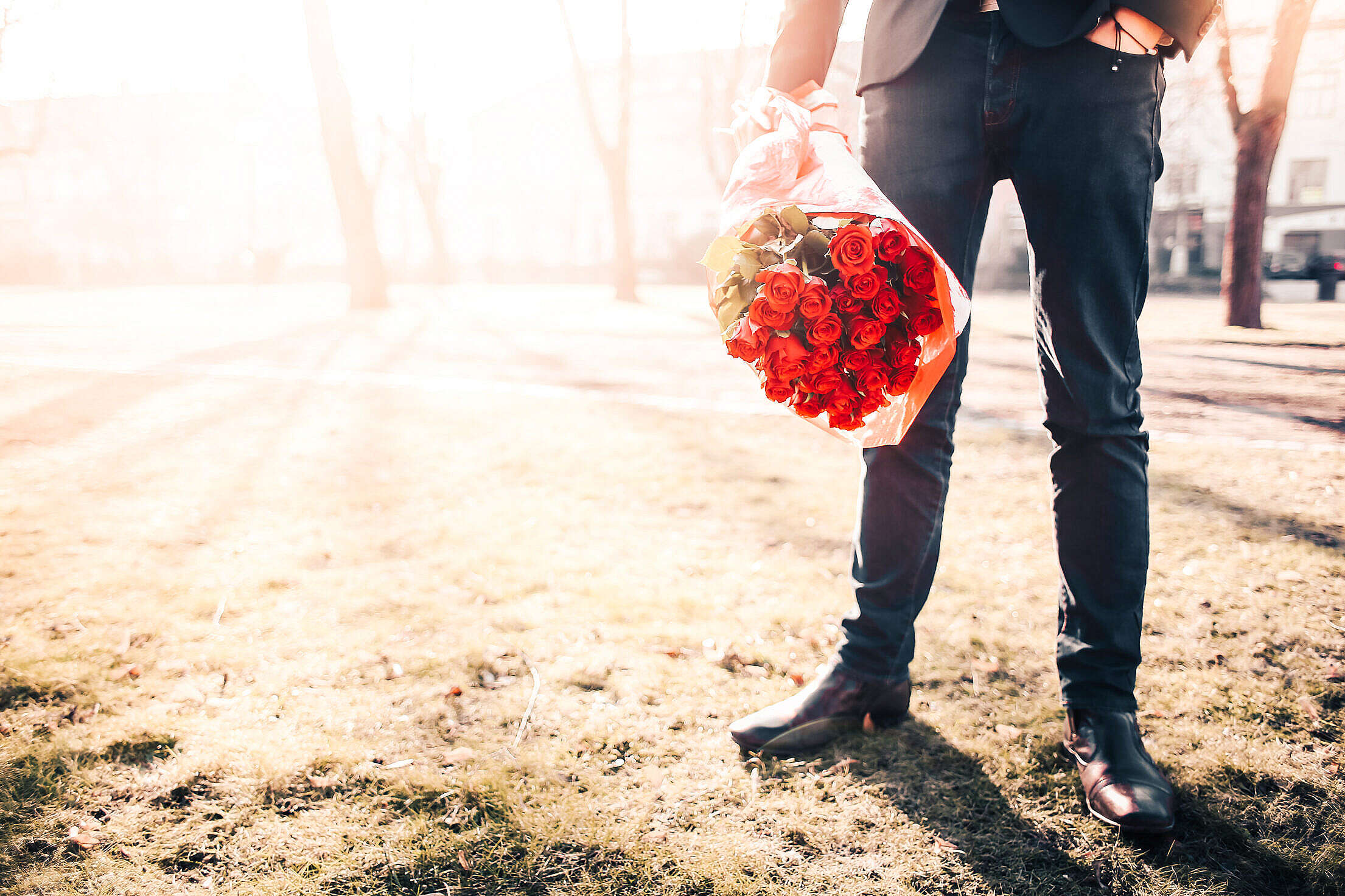 Man With Roses Waiting for his Lady Free Stock Photo