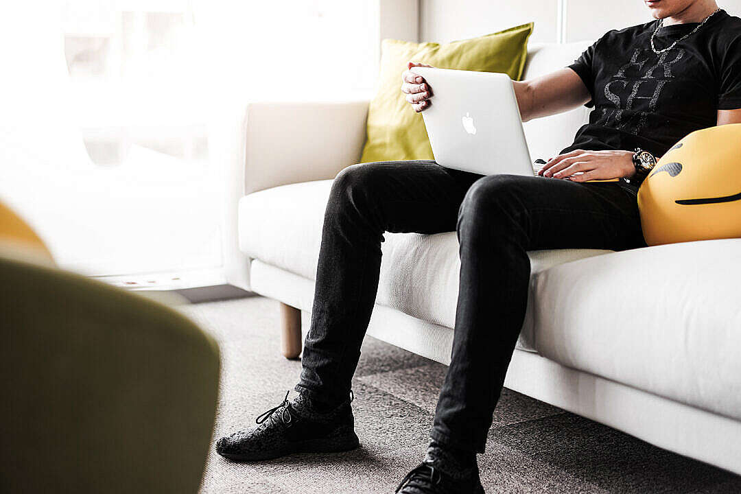 Download Man Working from the White Sofa in the Office FREE Stock Photo
