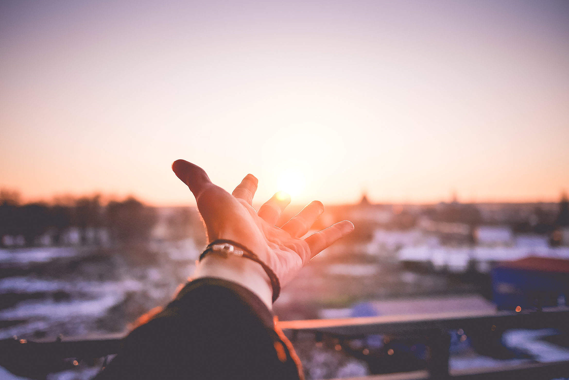 Man’s Hand is Trying To Reach The Sun Free Stock Photo