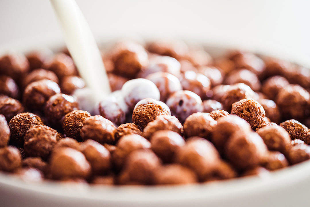 Download Milk Pouring on Cereal Chocolate Balls FREE Stock Photo