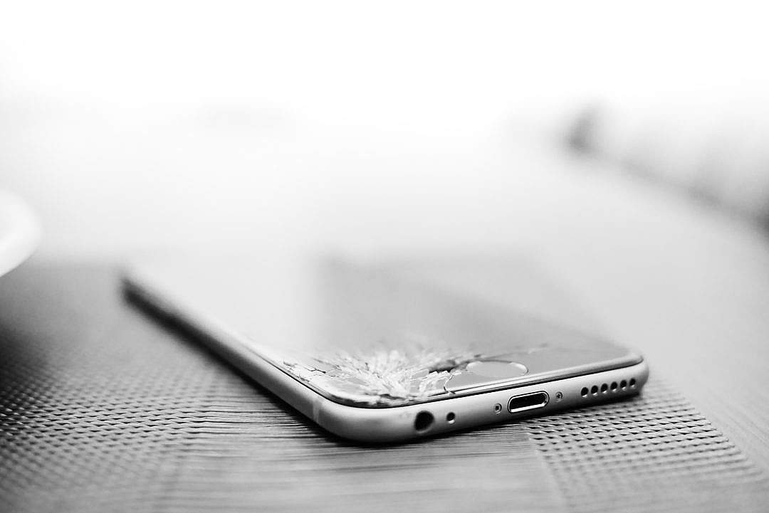 Download Minimalistic Crashed iPhone with Cracked Screen FREE Stock Photo