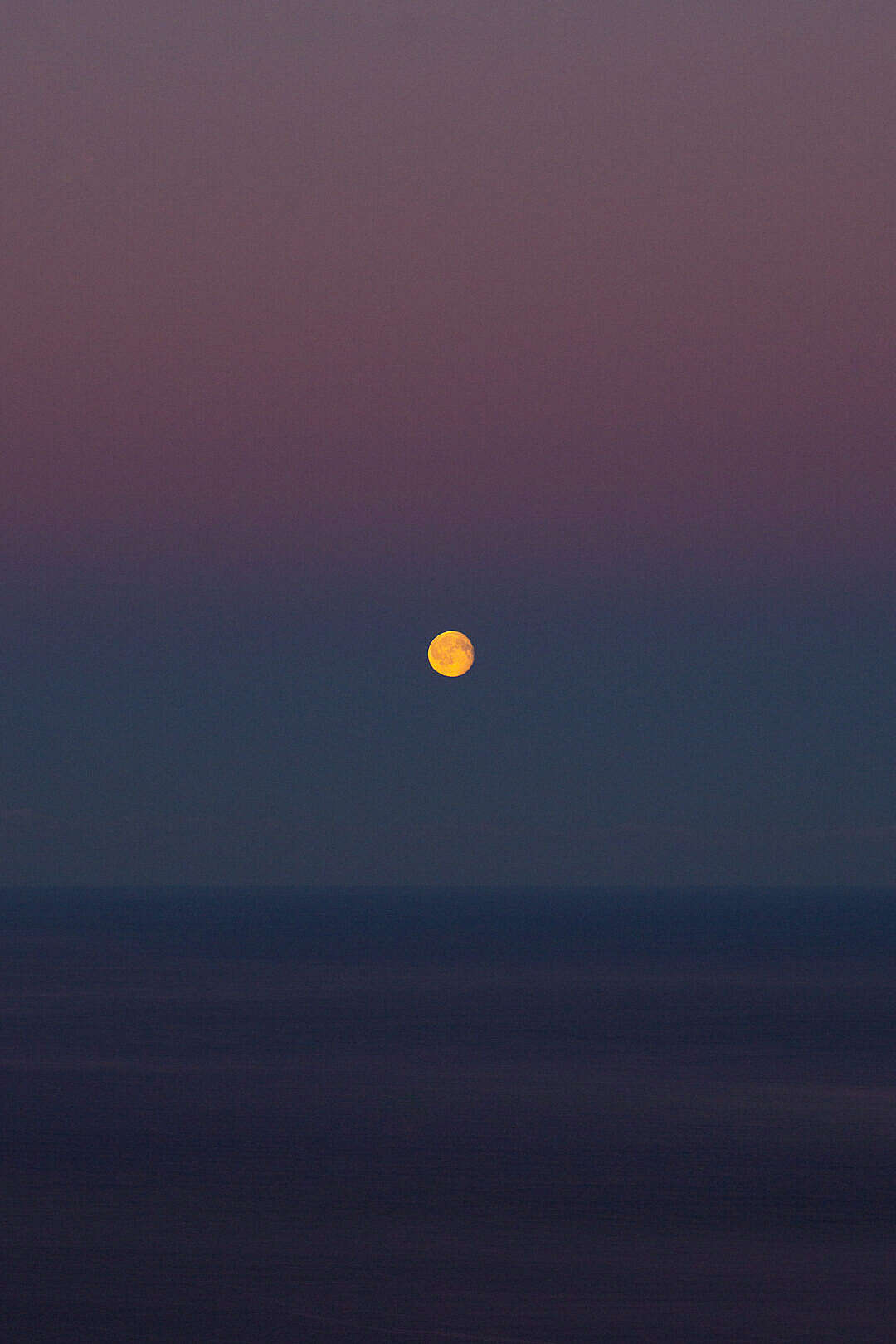 Moon over The Sea on a Colorful Dawn Sky