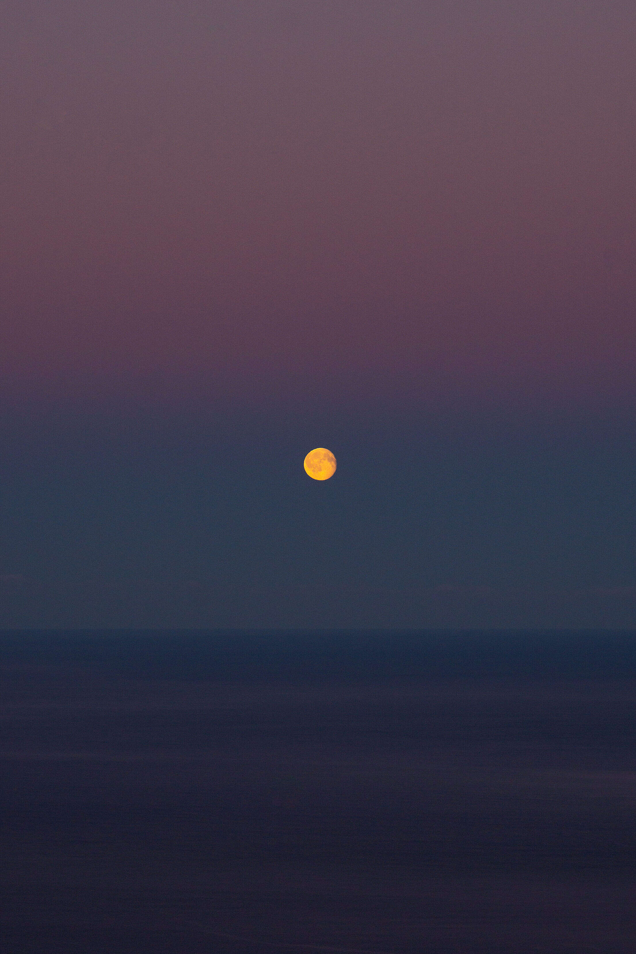 Moon over The Sea on a Colorful Dawn Sky Free Stock Photo