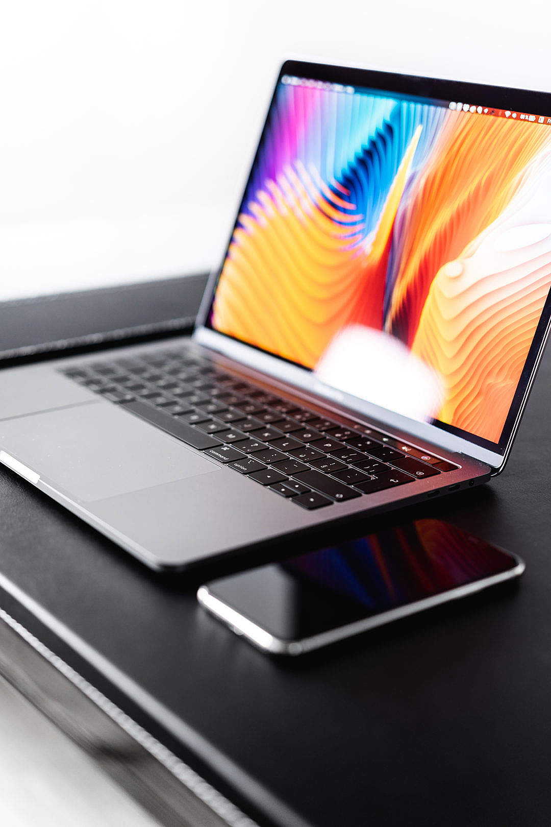 Download New MacBook Pro with iPhone FREE Stock Photo