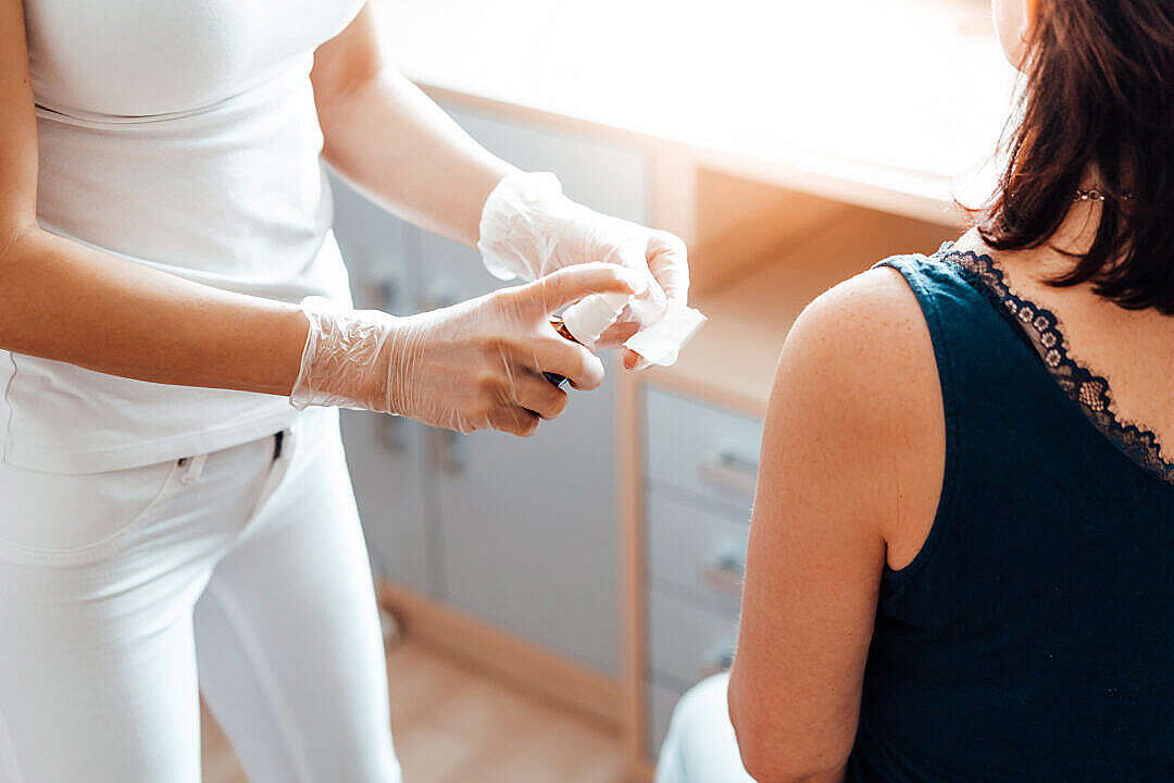 Download Nurse Preparing a Woman for Vaccination FREE Stock Photo