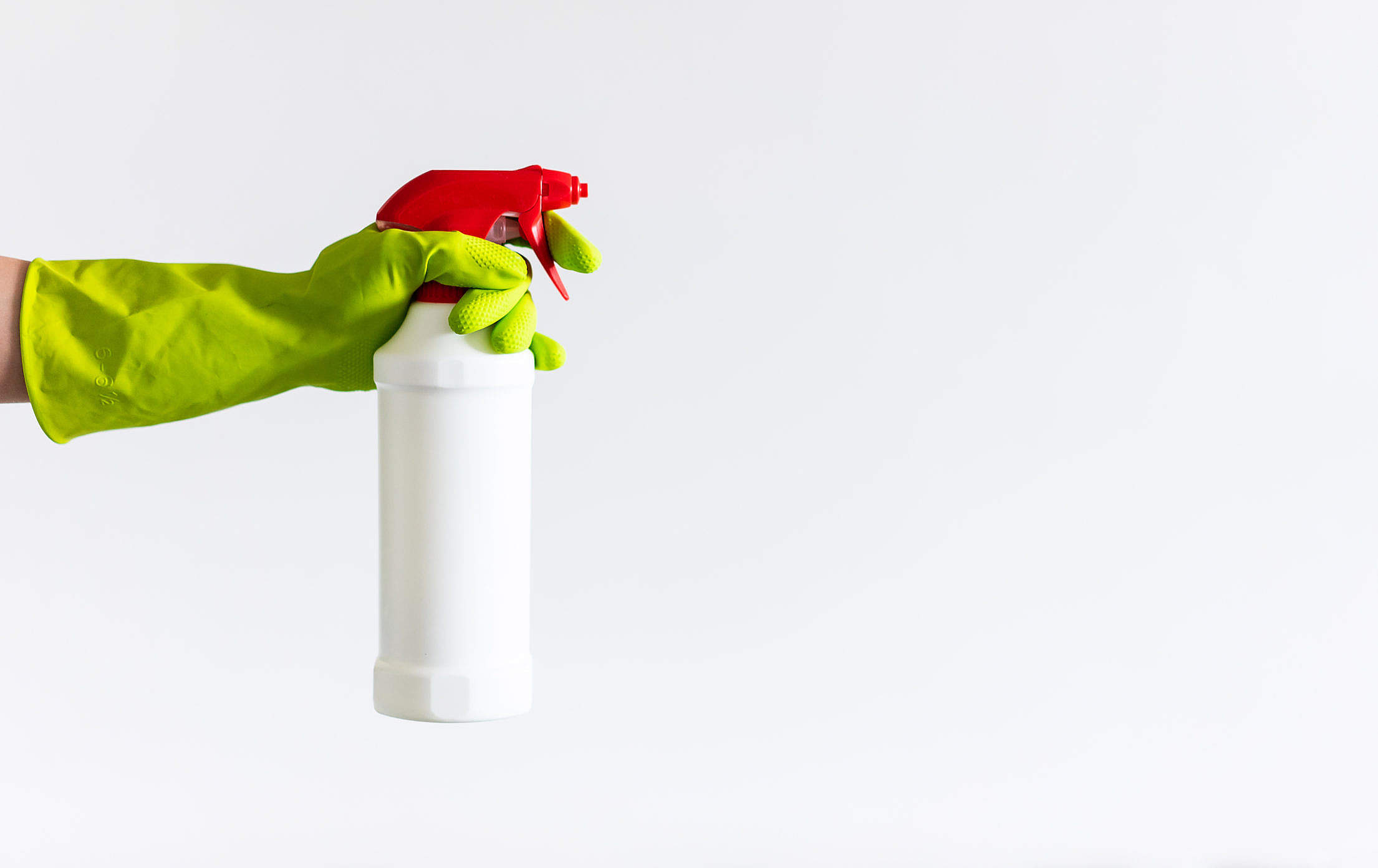Person Holding a Cleaning Agent Spray Free Stock Photo