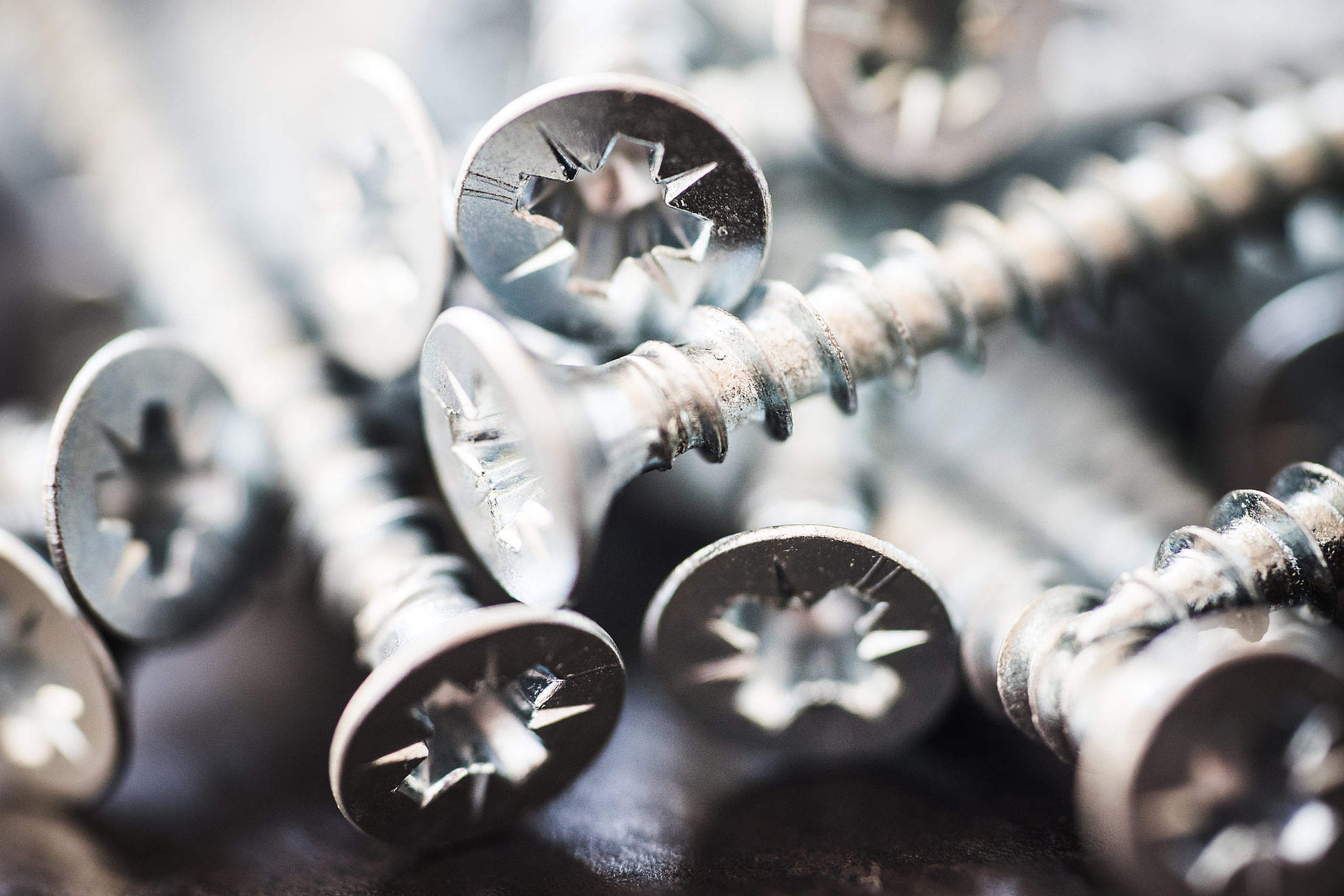 Pile of Silver Flat Crosshead Screws Close Up #1 Free Stock Photo
