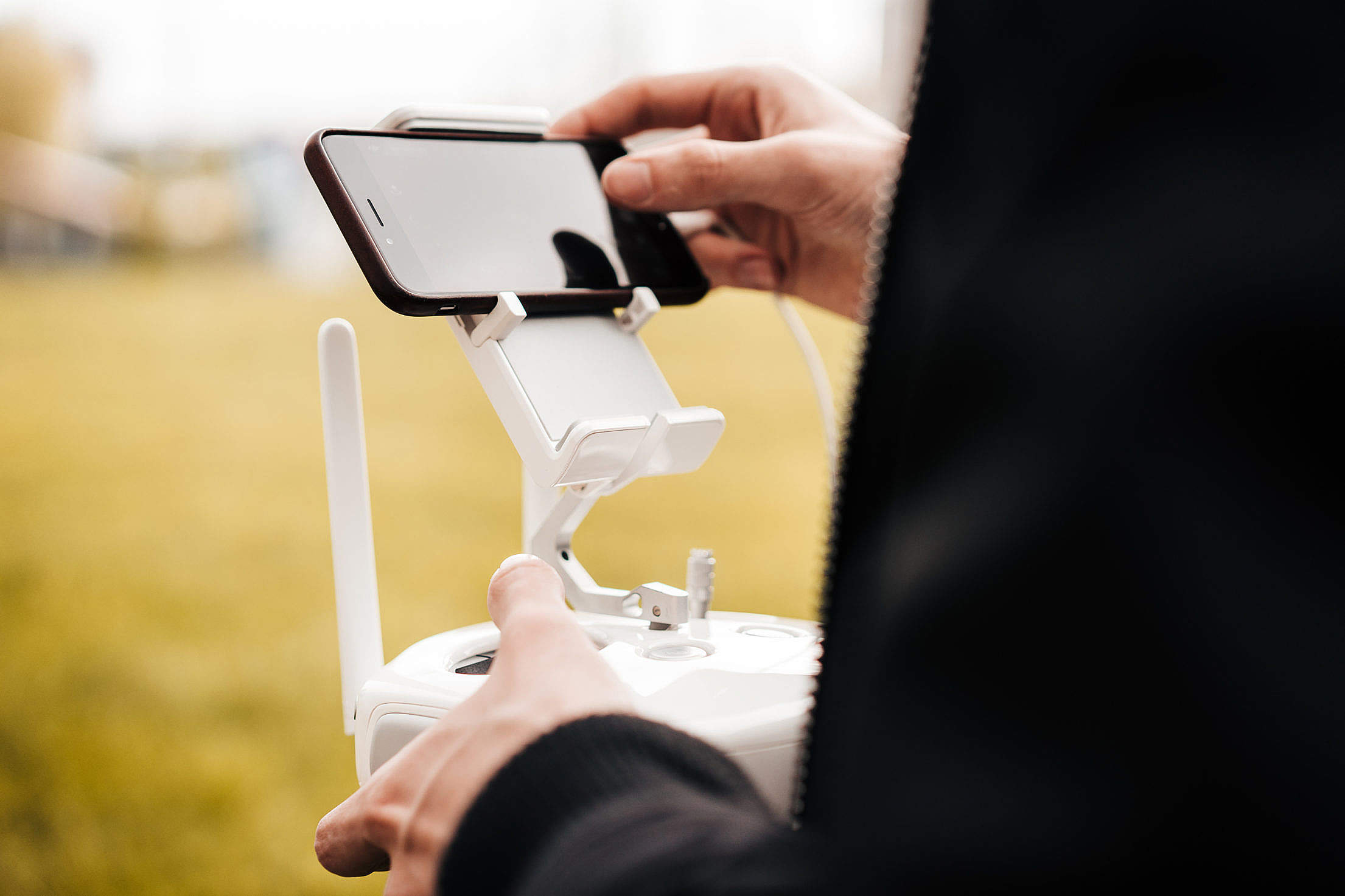 Pilot Controlling FPV Drone with Smarphone Free Stock Photo