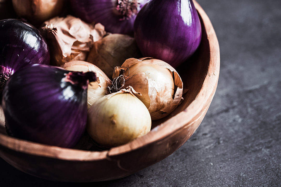 Red and Yellow Onions in a Wooden Bowl