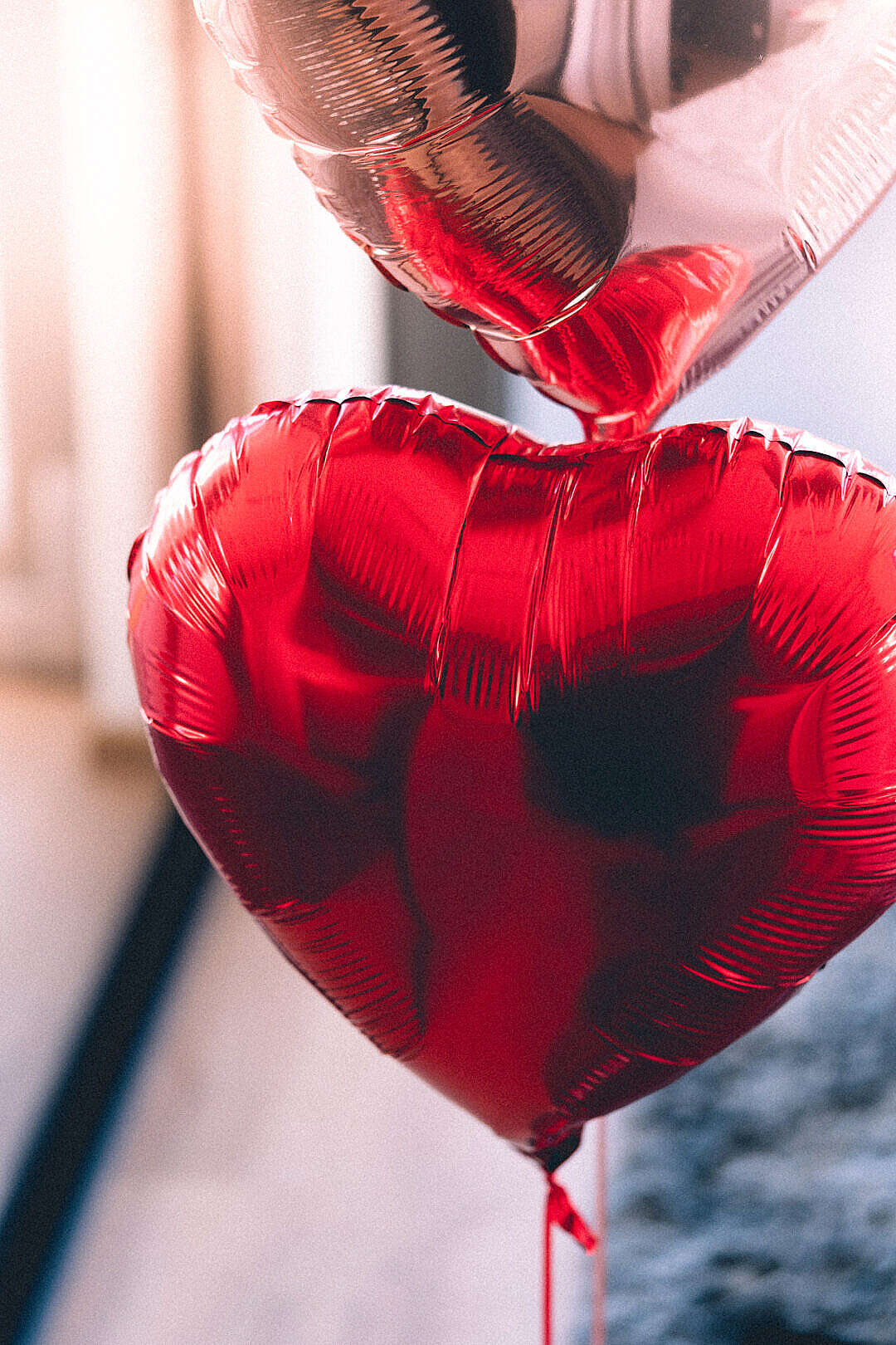 Download Red Heart-Shaped Metallic Balloon FREE Stock Photo