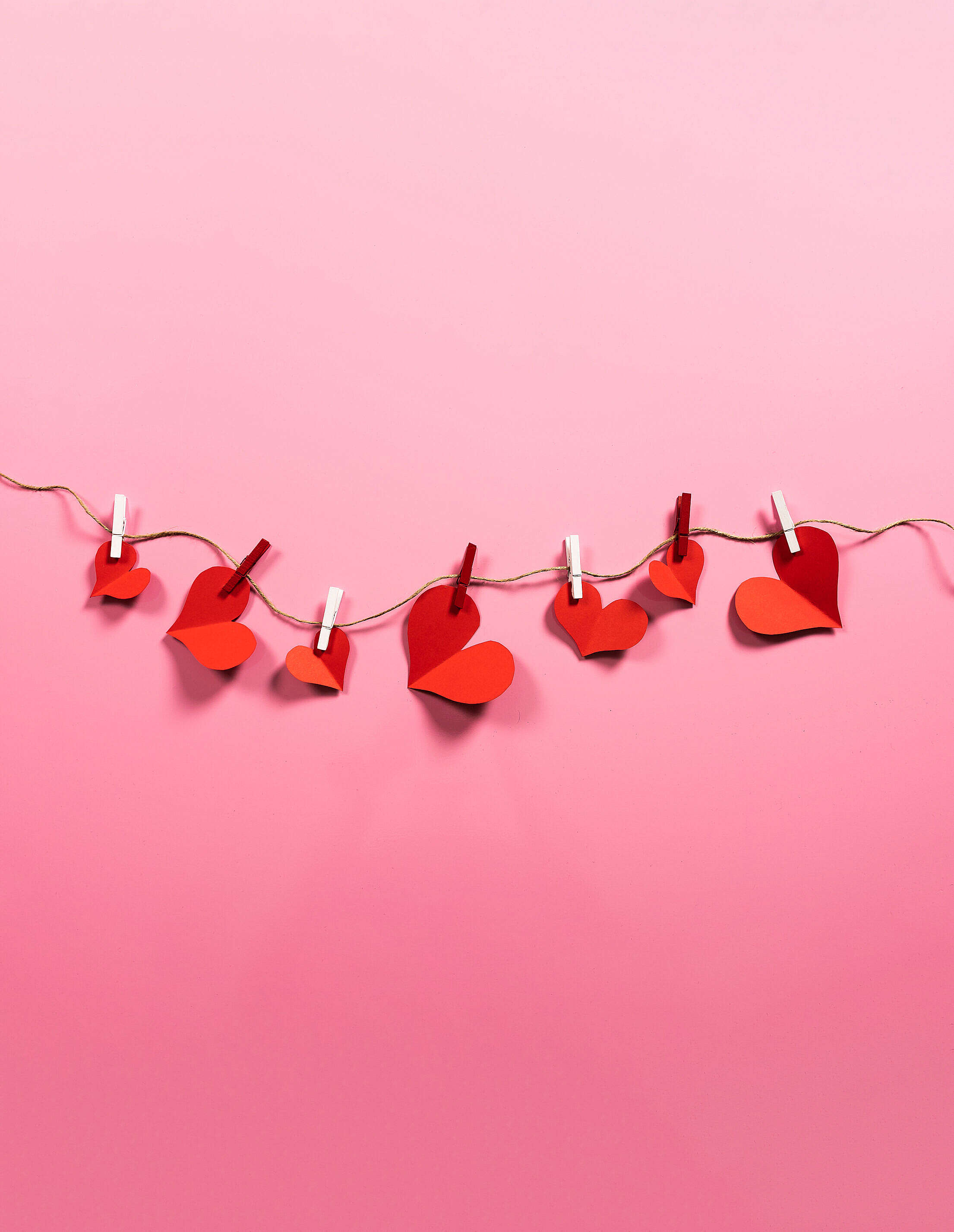 Romantic Love Paper Red Hearts Hanging on a String Free Stock Photo