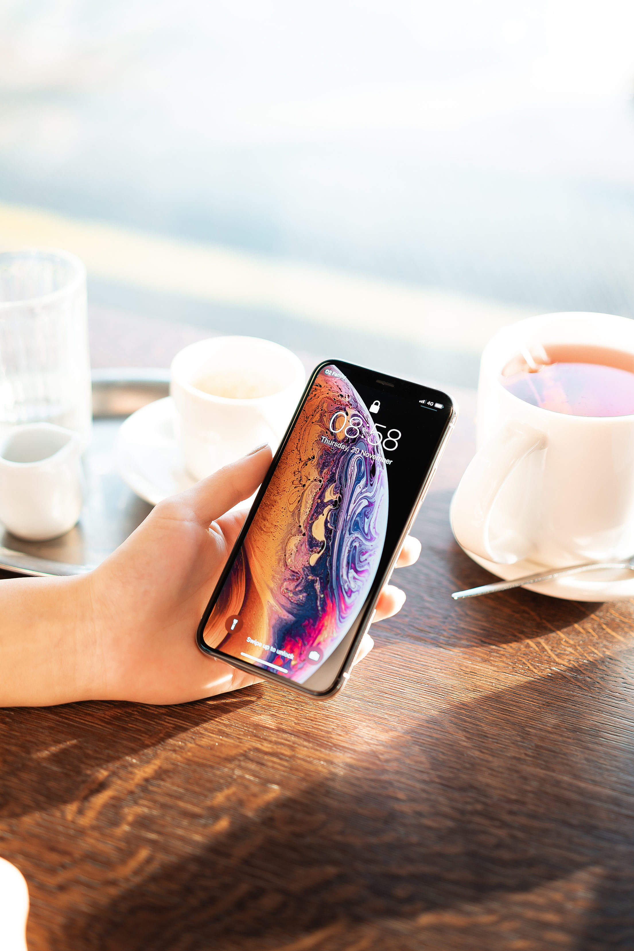 Showing an iPhone XS in Café Free Stock Photo