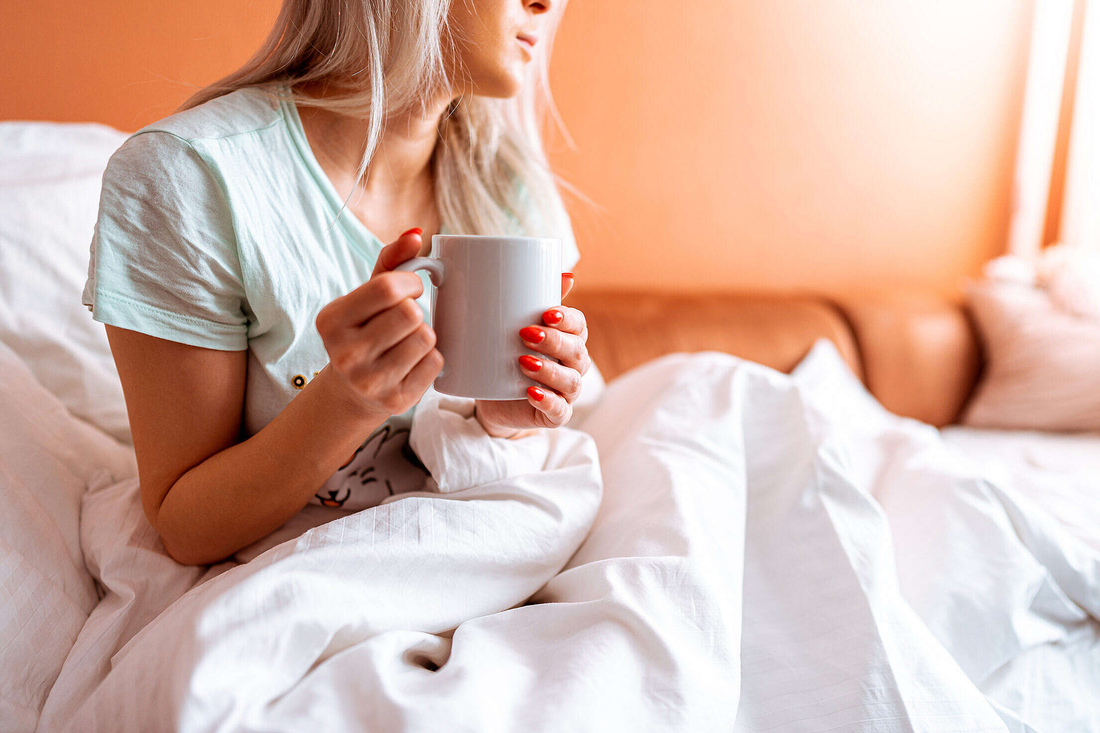 Sick Woman Holding a Cup of Tea Free Stock Photo