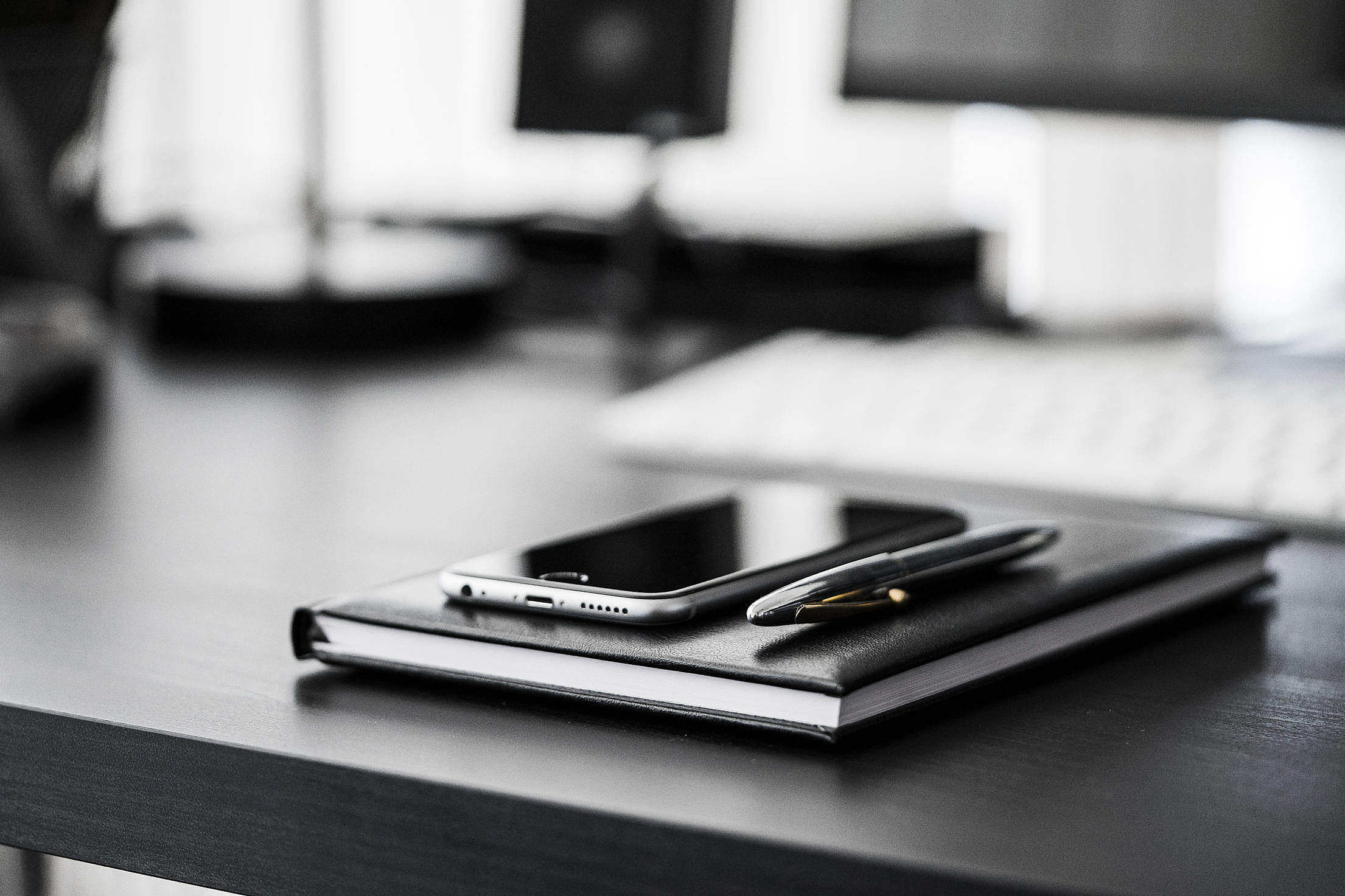 Smartphone, Diary and Silver Pen on Black Workspace Desk Free Stock Photo