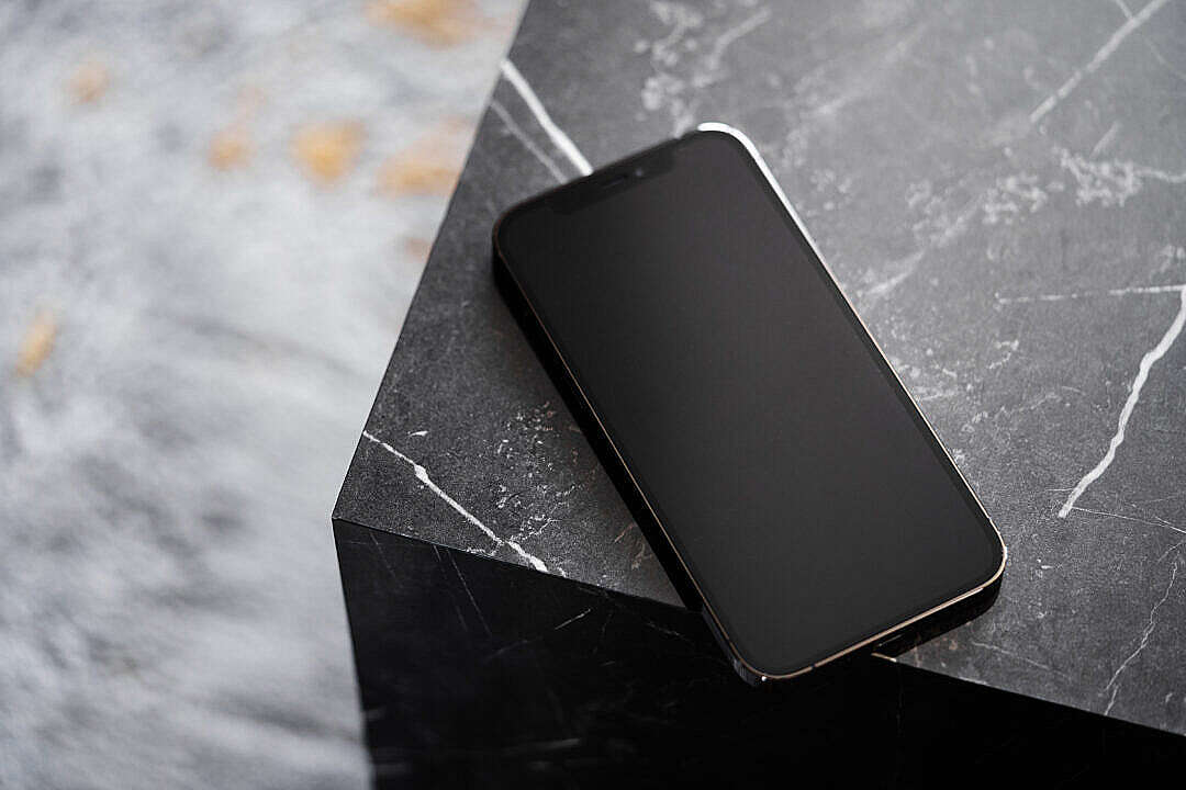 Download Smartphone on Black Marble Table FREE Stock Photo