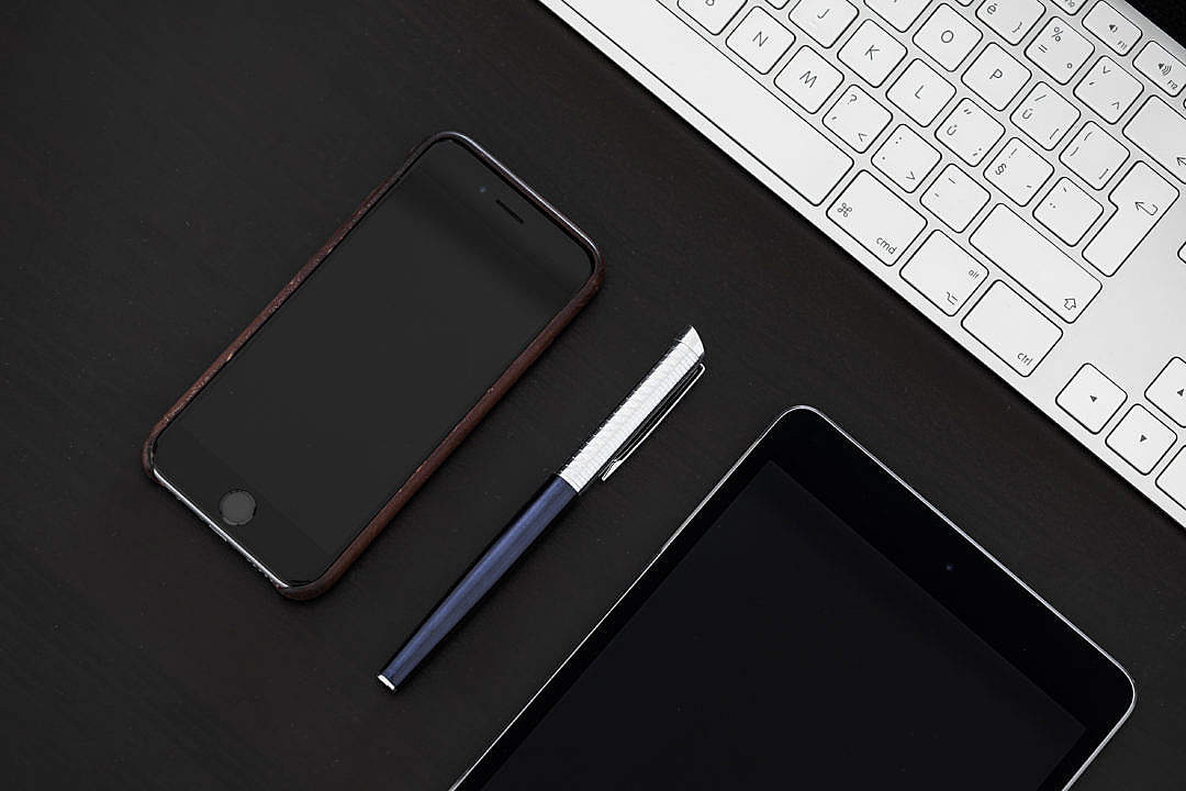 Smartphone with Pen on Office Desk From Above