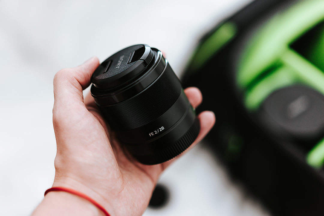 Download Sony 28mm f2 Lens and a Camera Bag FREE Stock Photo