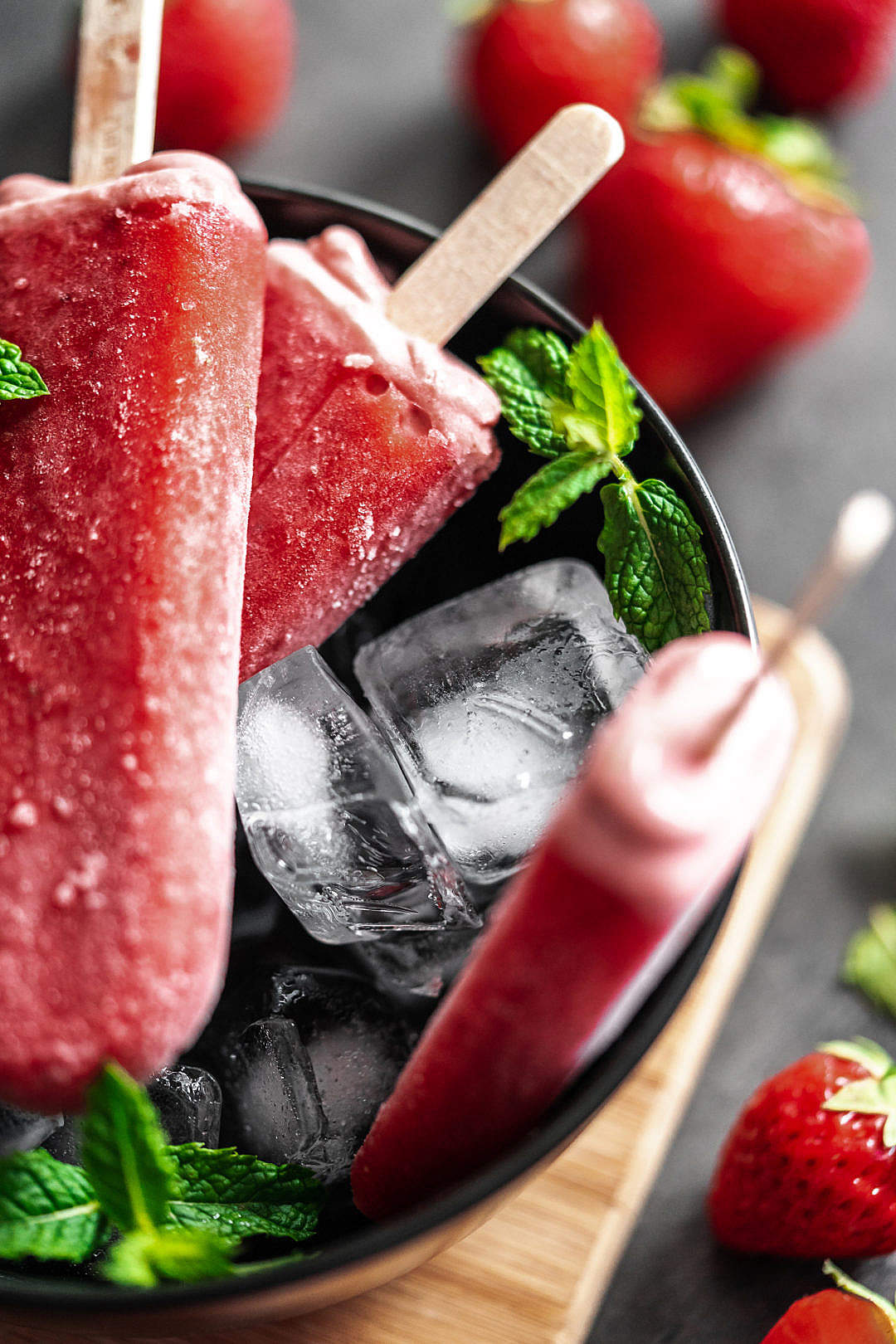 Strawberry Ice Lollies in a Black Bowl