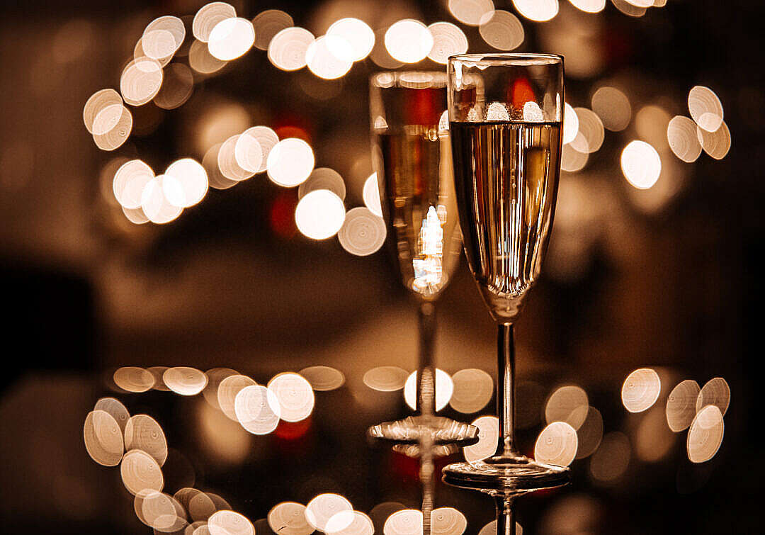 Two Glasses with Champagne on Glass Table