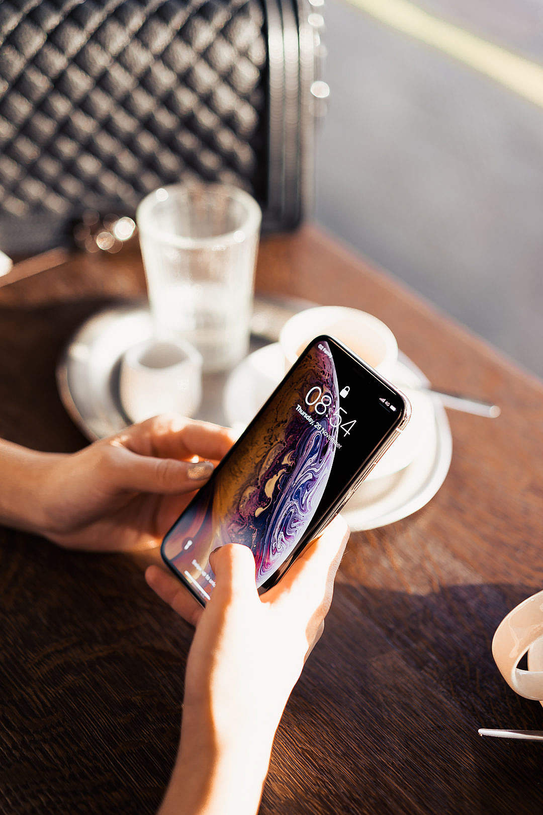 Download Using Modern Smartphone in a Café FREE Stock Photo