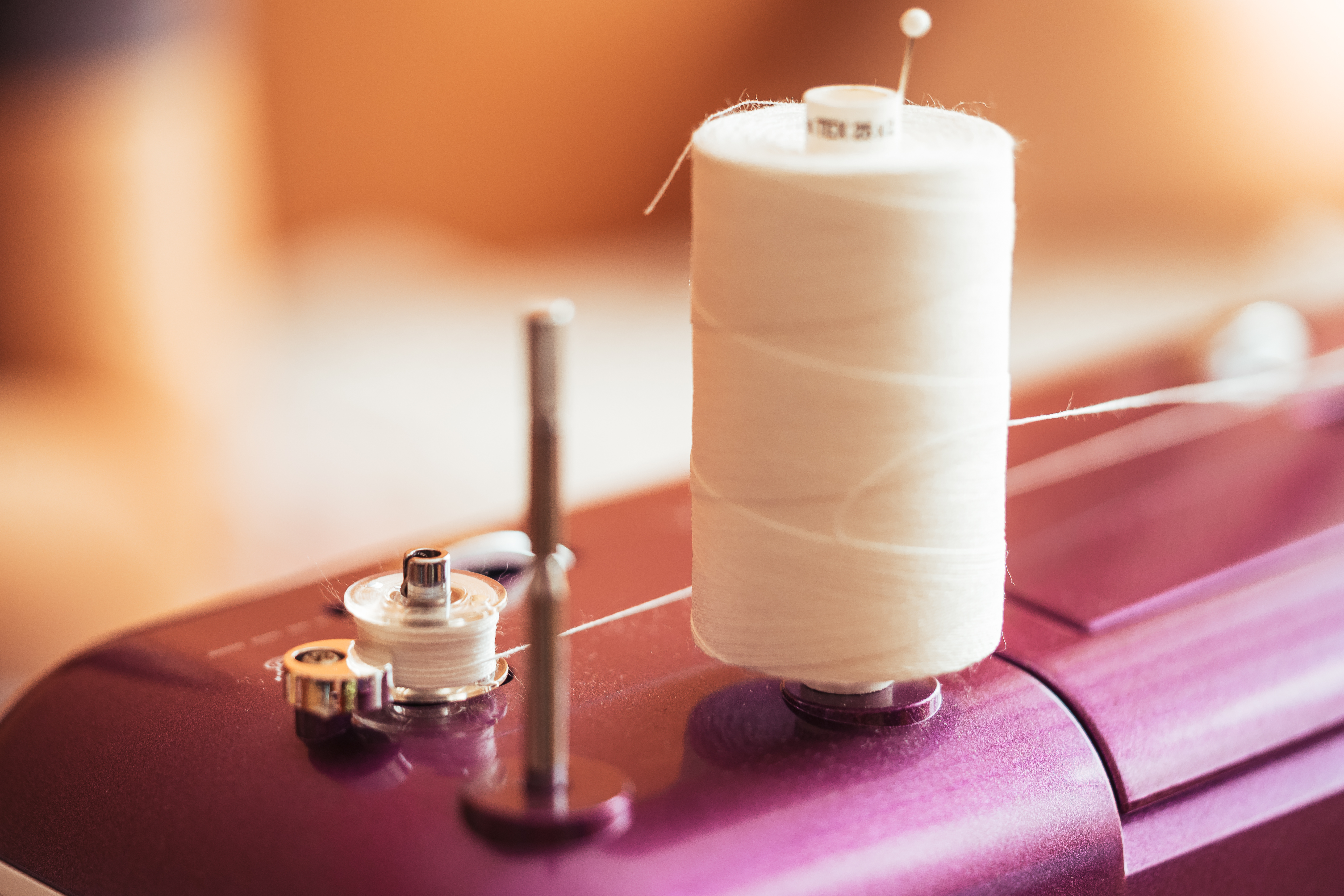 Cotton reel thread and sewing needle hi-res stock photography and
