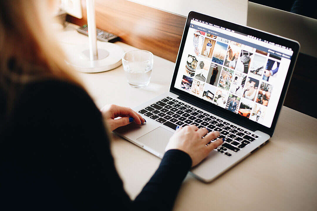 Woman Browsing Tumblr on Her Laptop