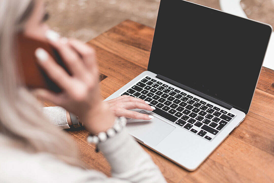 Woman Calling While Working Remotely on Laptop