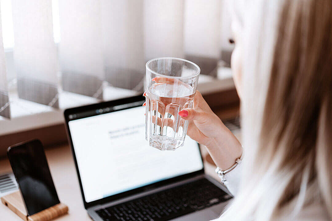 Download Woman Drinking Still Water at Work FREE Stock Photo