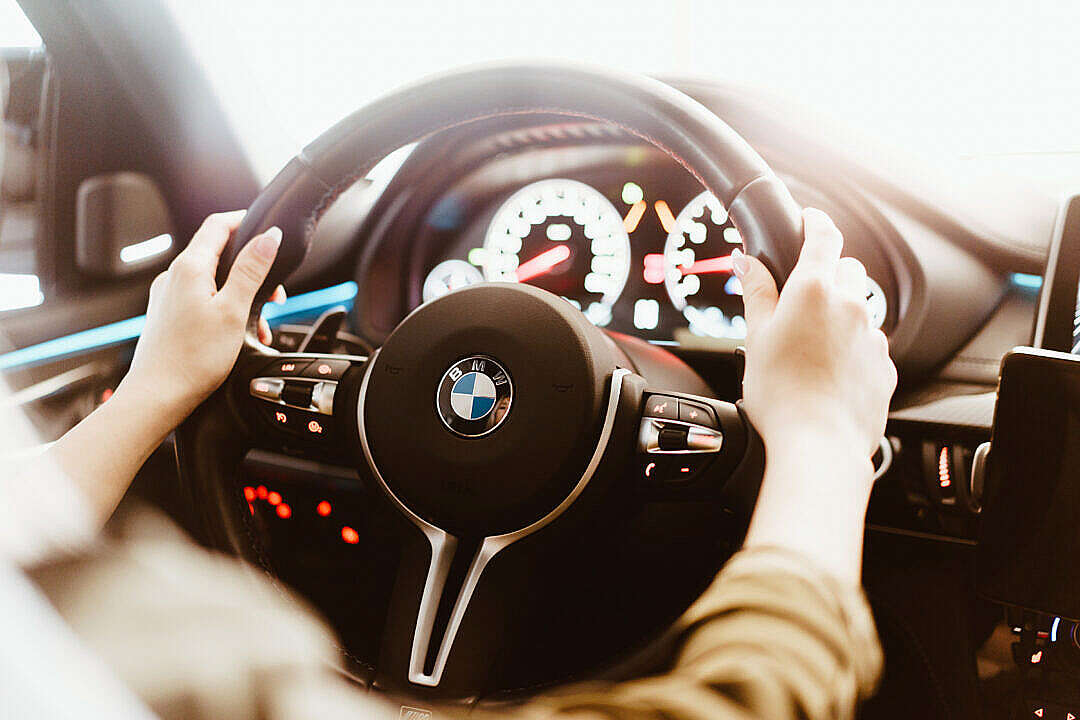 Woman Driving a BMW Luxury Car