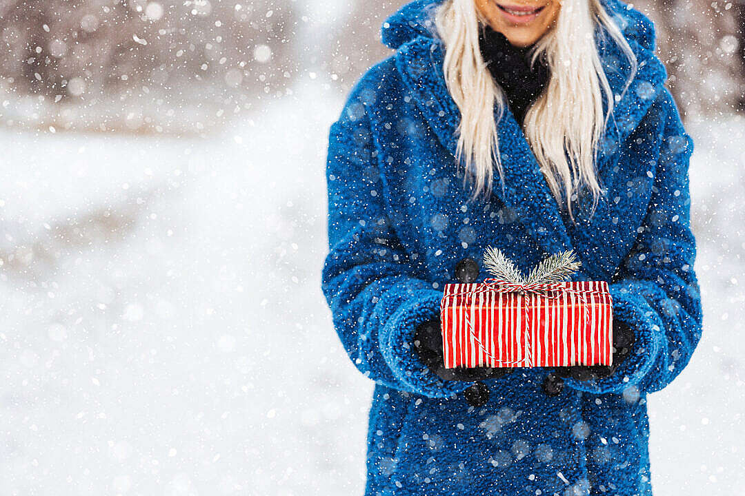 Woman Holding a Christmas Present