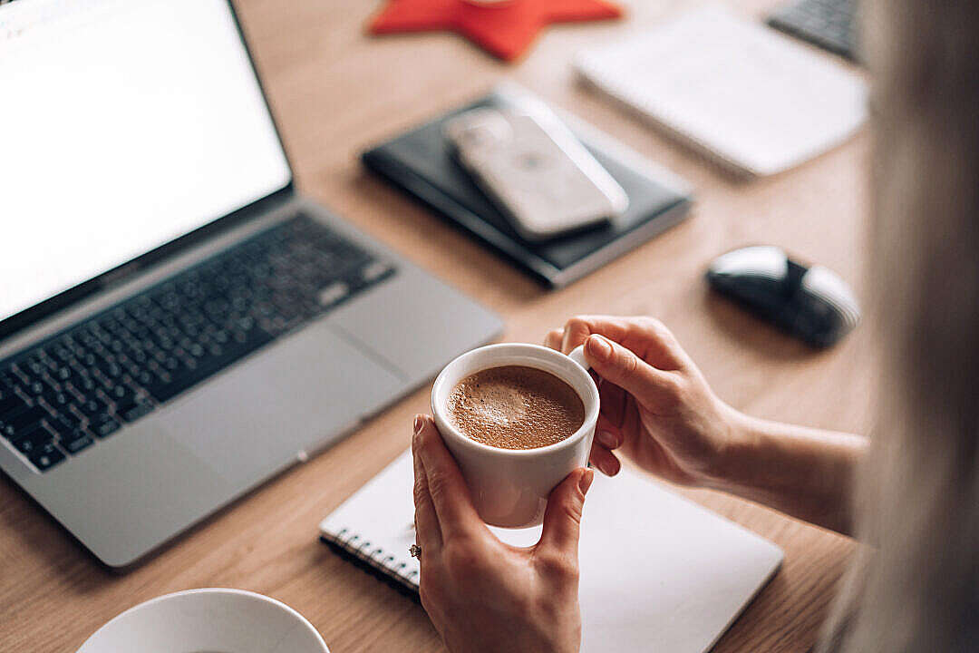 Download Woman Holding a Cup of Coffee at Work Home Office FREE Stock Photo
