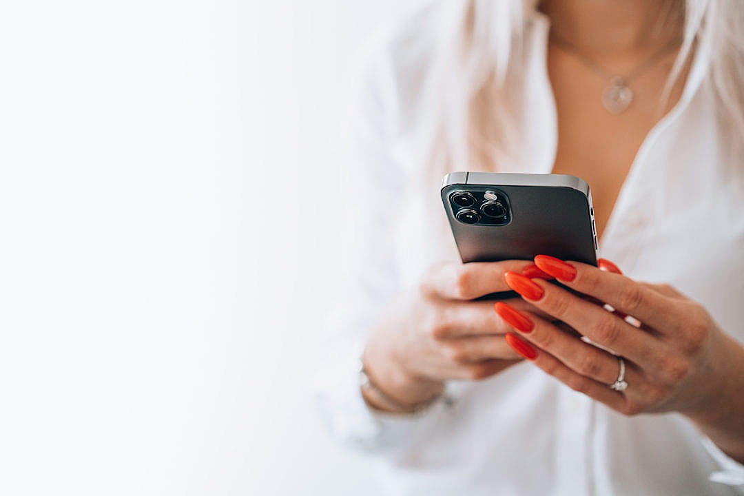 Download Woman Holding a Smartphone FREE Stock Photo