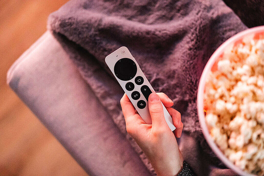 Download Woman Holding Apple TV Remote Control FREE Stock Photo