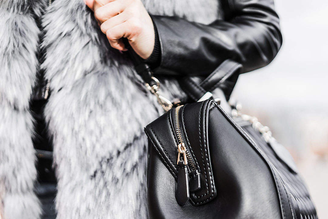 Download Woman Holding Her Black Leather Bag Close Up FREE Stock Photo