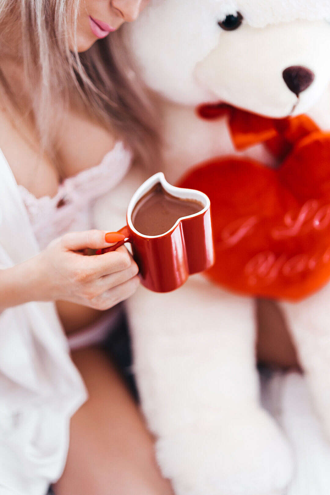 Woman Holding Red Heart Shaped Coffee Mug