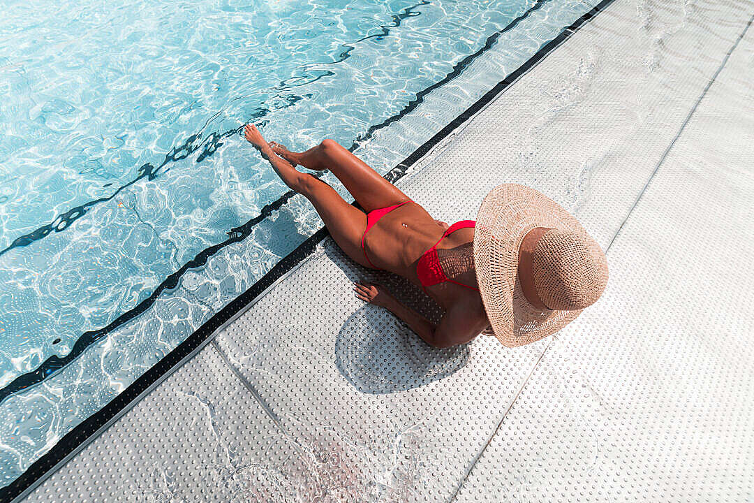Woman in Bikini Sunbathing at The Pool