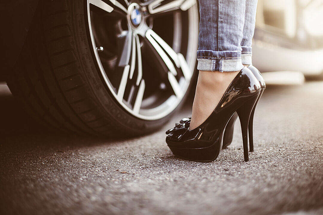 Download Woman in Black High Heels Standing Next to a Car FREE Stock Photo