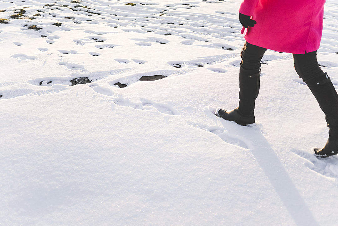 Woman in Black Knee High Boots Walking in Snow