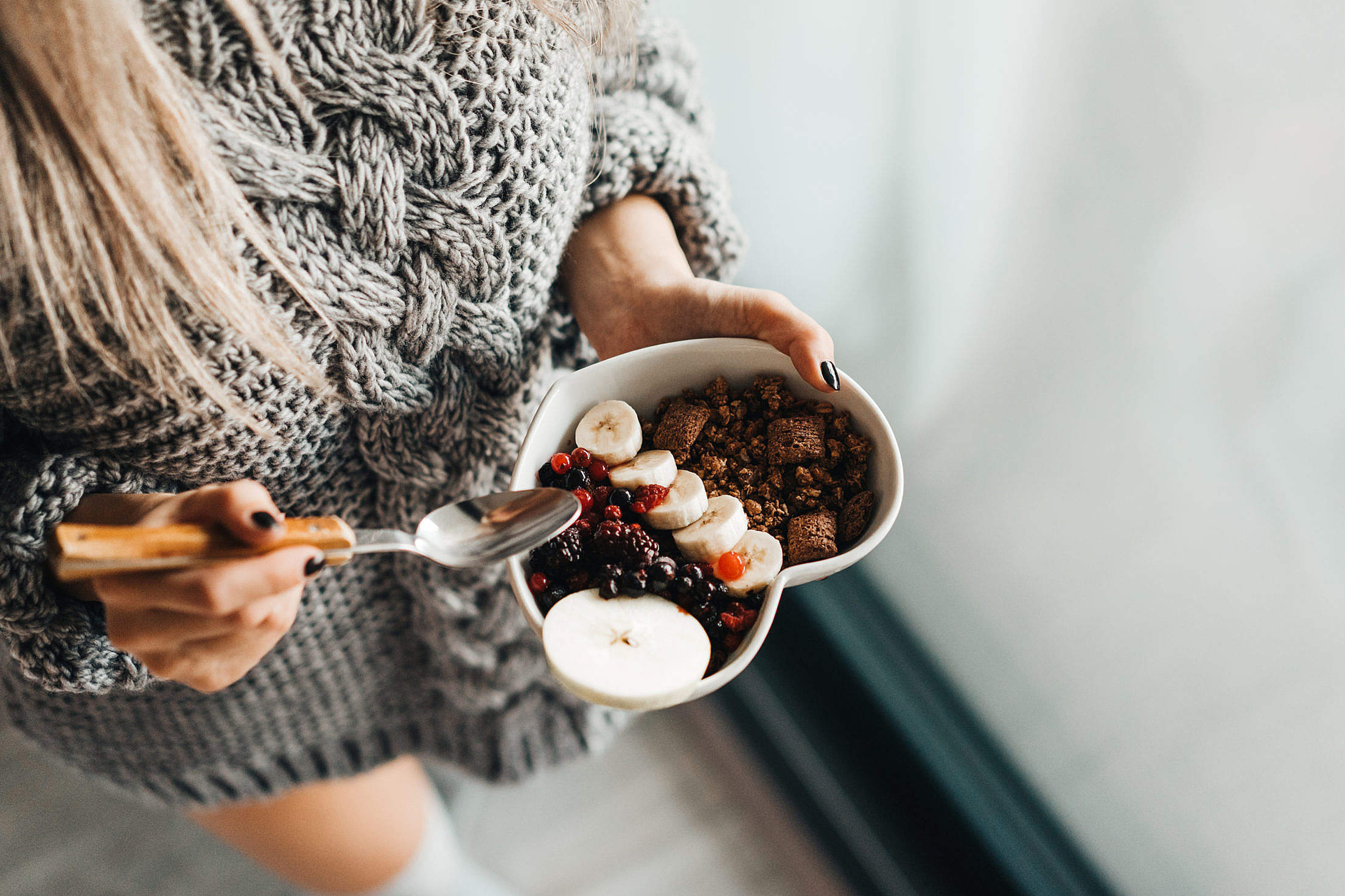 Woman in Knitted Sweater Enjoying Morning Breakfast Free Stock Photo
