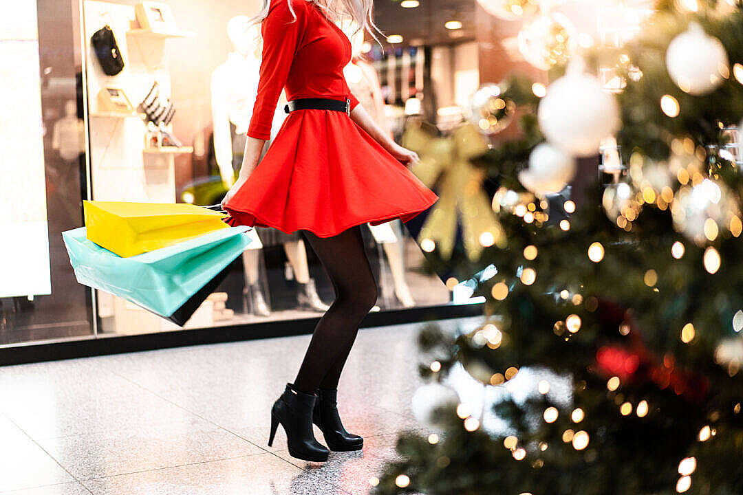 Woman in Red Dress Enjoying Christmas Shopping