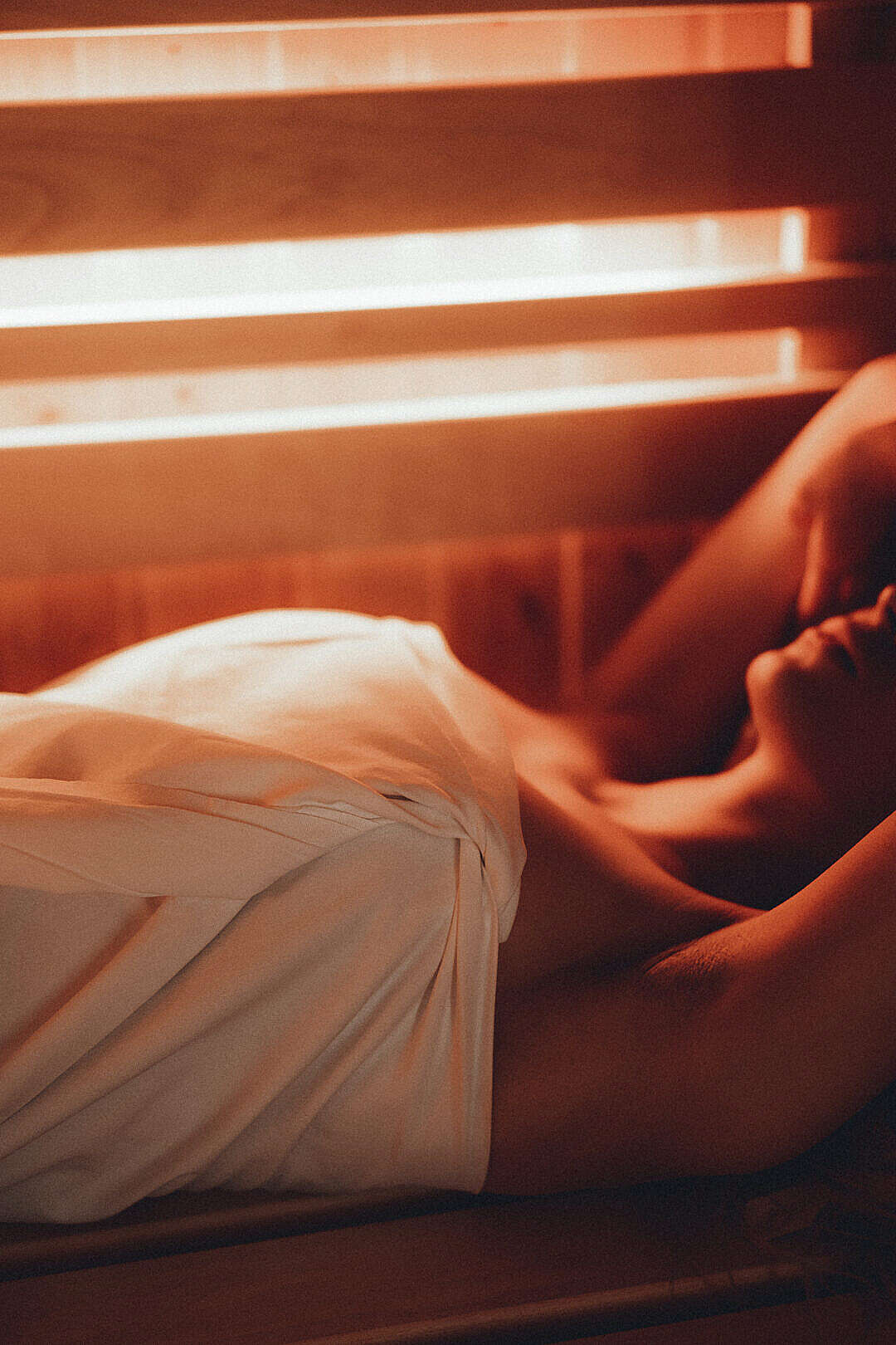 Woman Lying in a Finnish Sauna Close Up Vertical
