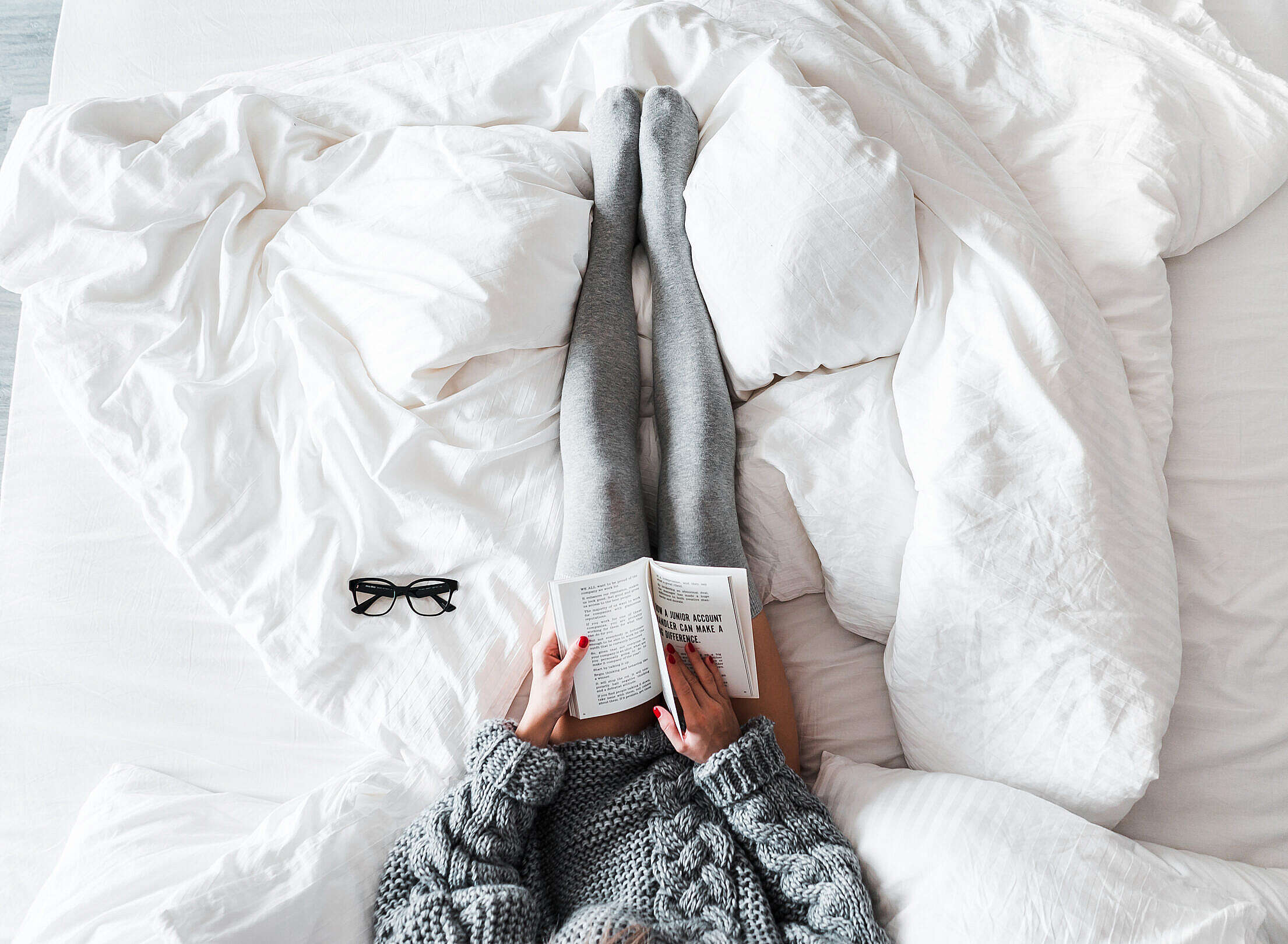 Woman Reading a Book in Bed Free Stock Photo
