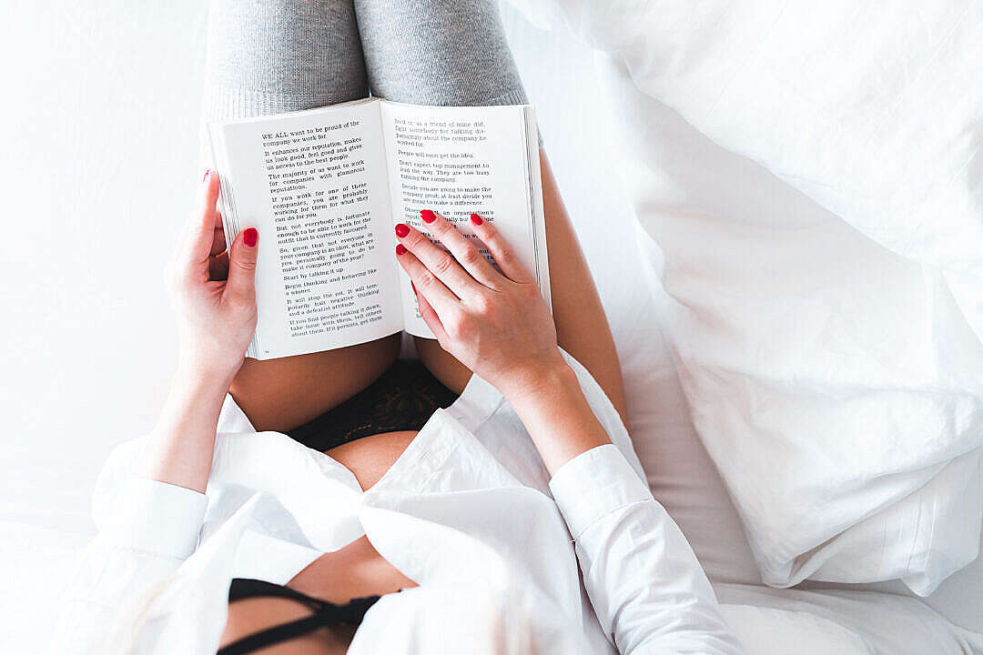 Download Woman Reading a Book in Bed FREE Stock Photo