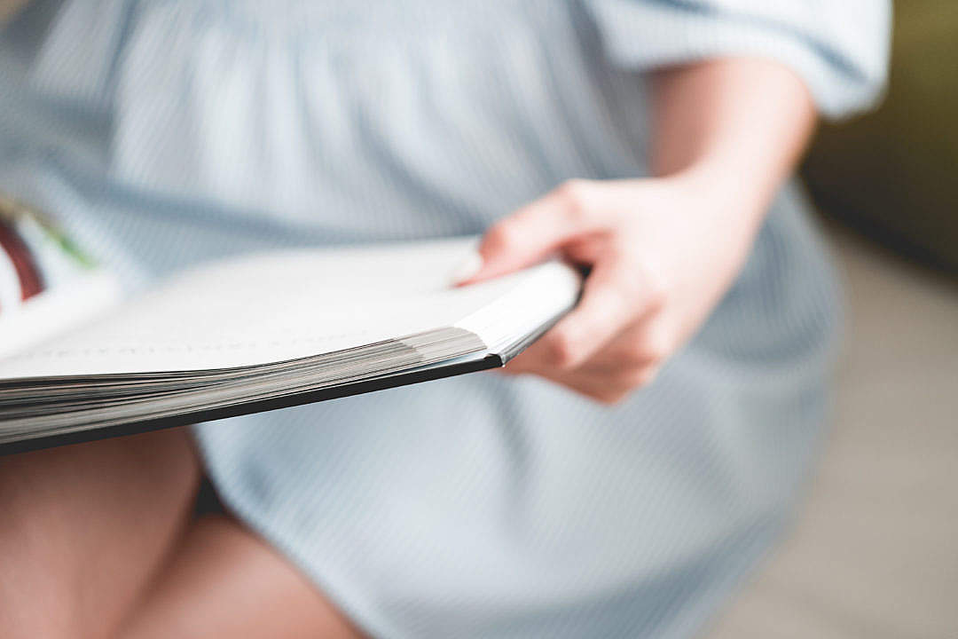 Download Woman Reading a Hardback Book FREE Stock Photo
