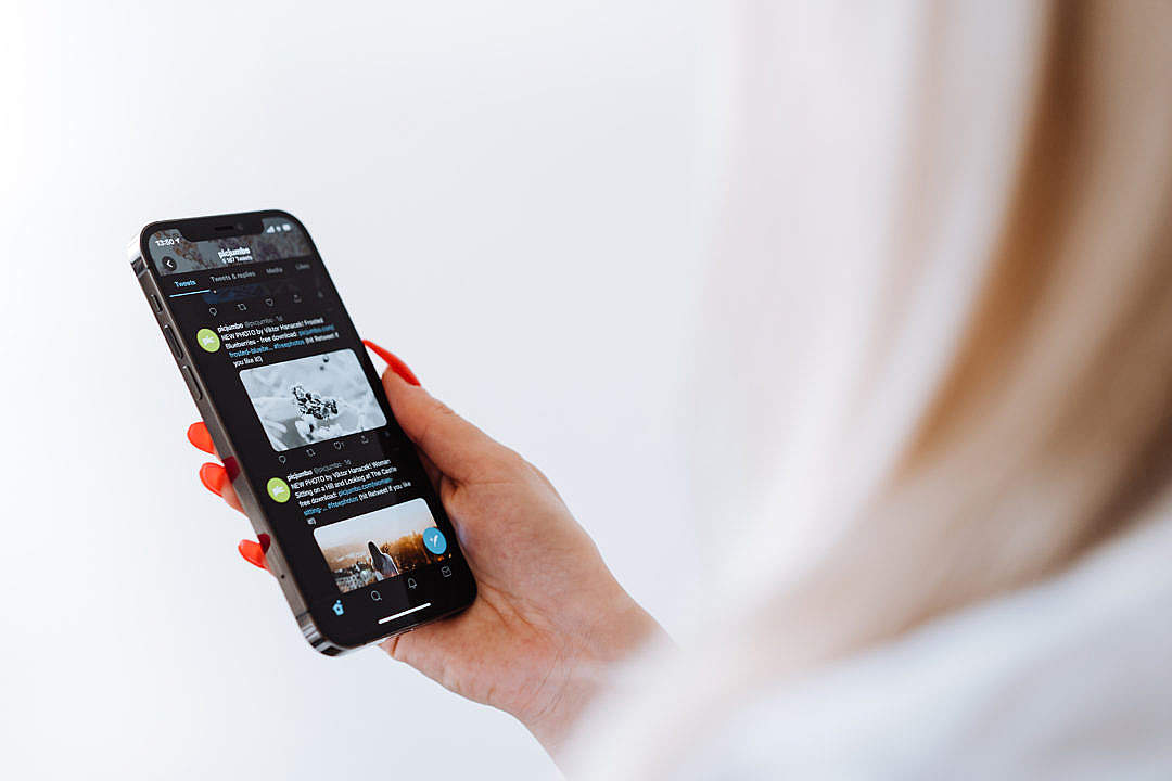 Woman Reading Twitter on a New Smartphone