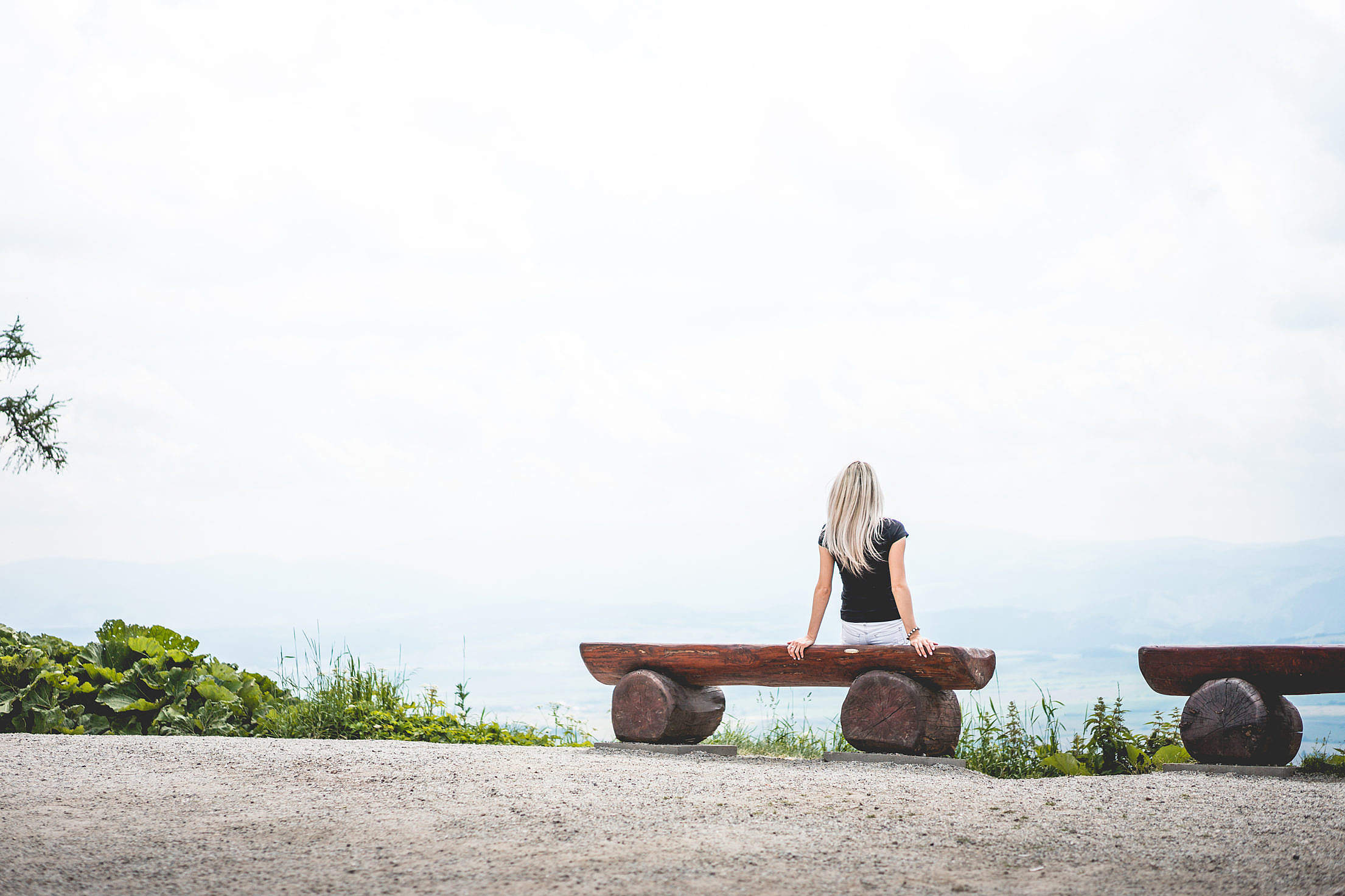 Woman Sitting on a Bench Place for Text Free Stock Photo